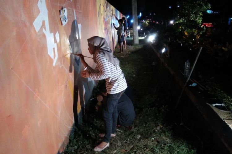 Sejumlah komunitas seni melukis di Trenggalek, Jawa Timur, melukis mural di tembok dinding kolam renang Tirta Jwalita (12/6/2018).