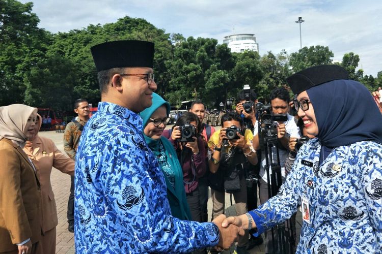 Gubernur DKI Jakarta Anies Baswedan menyalami komandan apel hari ibu di Lapangan IRTI Monas, Jumat (22/12/2017). 
