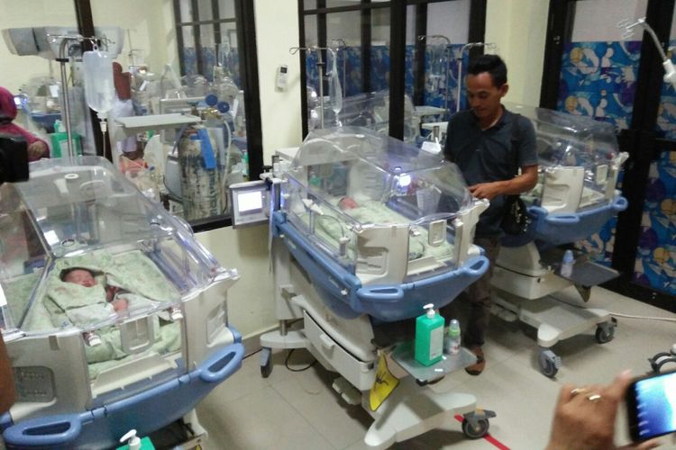 Zaenal Abidin saat melihat bayi kembar tiga yang baru dilahirkan istrinya,  Atina,  Senin (1/10/2018) malam. 