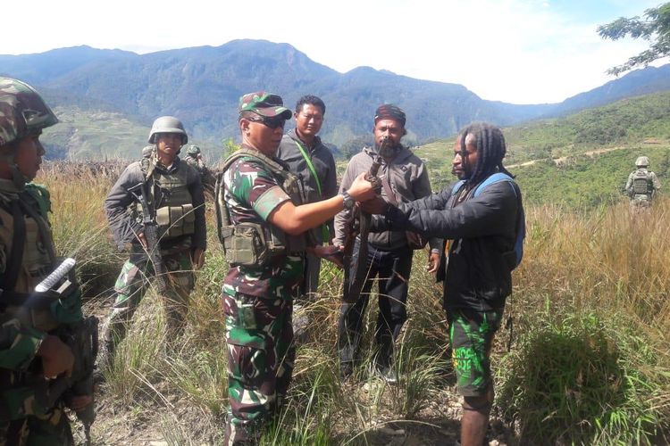 Telangga Gire menyerahkan satu pucuk senjata api jenis Mosser kepada Dandim 1714/PJ Letkol Inf Agus Sunaryo diDistrik Ilu, Kabupaten Puncak Jaya, Papua (08/06/2019)