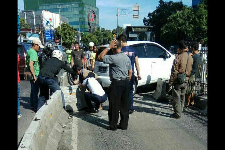 Sebuah mobil sedan berwarna putih menabrak separator di dekat Halte Warung Jati Transjakarta Koridor 6.