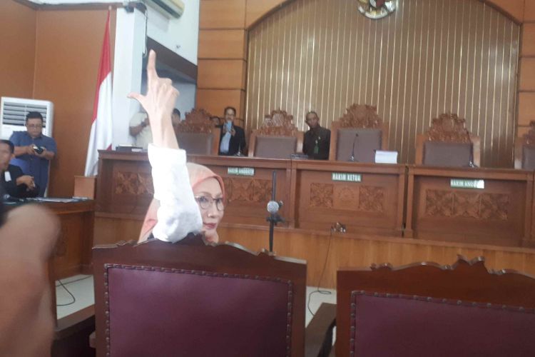 Terdakwa kasus penyebaran berita bohong atau hoaks, Ratna Sarumpaet mengacungkan simbol dua jari saat tiba di Ruang sidang utama, Pengadilan Negeri Jakarta Selatan, Kamis (28/2/2019). 