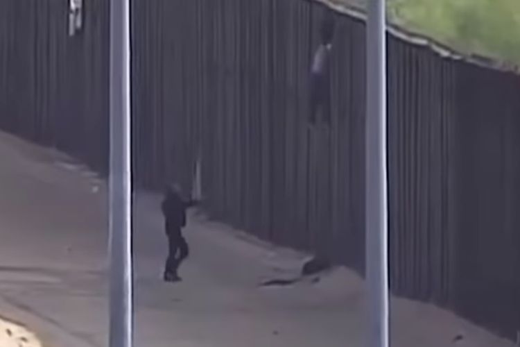 Tangkapan layar rekaman kamera pengawas yang memperlihatkan saat seorang gadis migran terjatuh ketika mencoba melewati pagar perbatasan AS-Meksiko.
