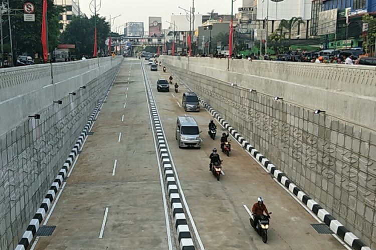 Kendaraan melintasi underpass Mampang-Kuningan yang mulai diuji coba pada Rabu (11/2/2018). Pengendara sepeda motor tampak melambaikan tangan saat melintasi underpass tersebut. Warga tampak berdiri di samping underpass karena penasaran.