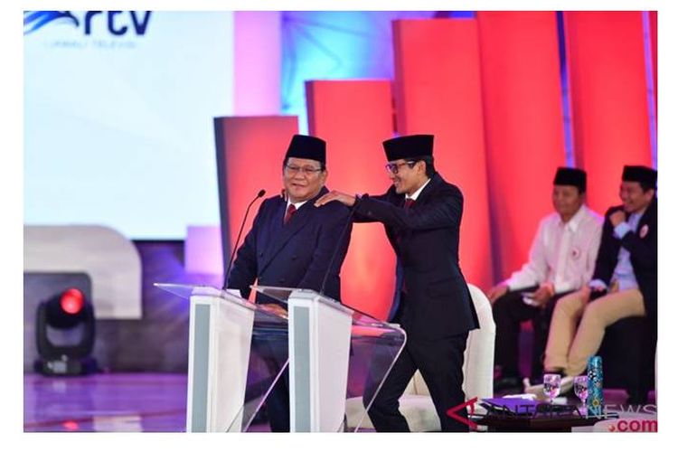 Sandiaga Uno memijat pundak Prabowo ketika ia ingin menanggapi pernyataan Jokowi.