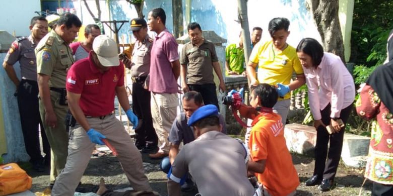 Polisi mengevakuasi mayat lelaki tanpa identitas yang ditemukan di saluran air pinggir jalan raya Semarang - Grobogan wilayah Desa Ketitang, Kecamatan Godong, Kabupaten Grobogan, Jawa Tengah, Kamis (27/12/2018).