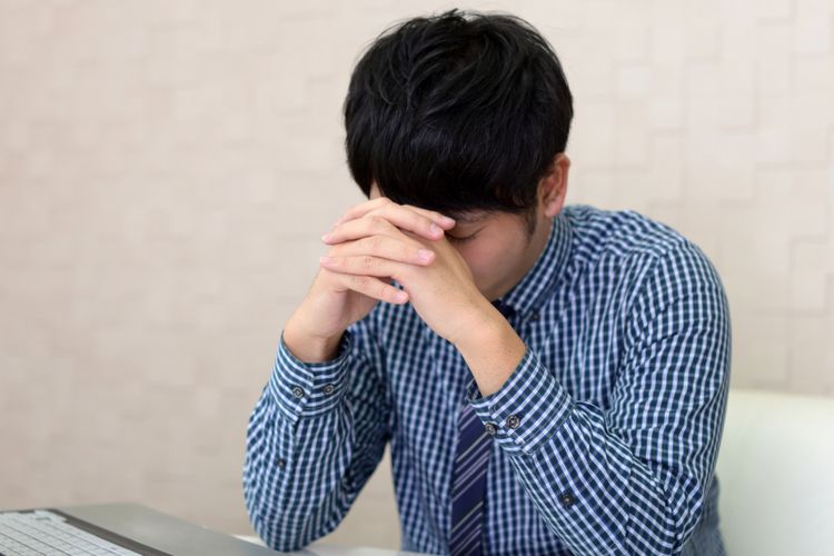 Tired and stressed Asian businessman