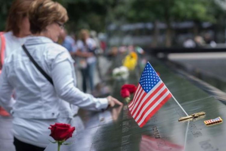 Para pengunjung menyentuh nama-nama korban tewas dalam serangan terhadap gedung World Trade Center di New York, AS, 11 September 2001 pada peringatan 15 tahun serangan teror itu, Minggu (11/9/2016). Pada 11 September 2017, mereka peringati 16 tahun serangan itu.
