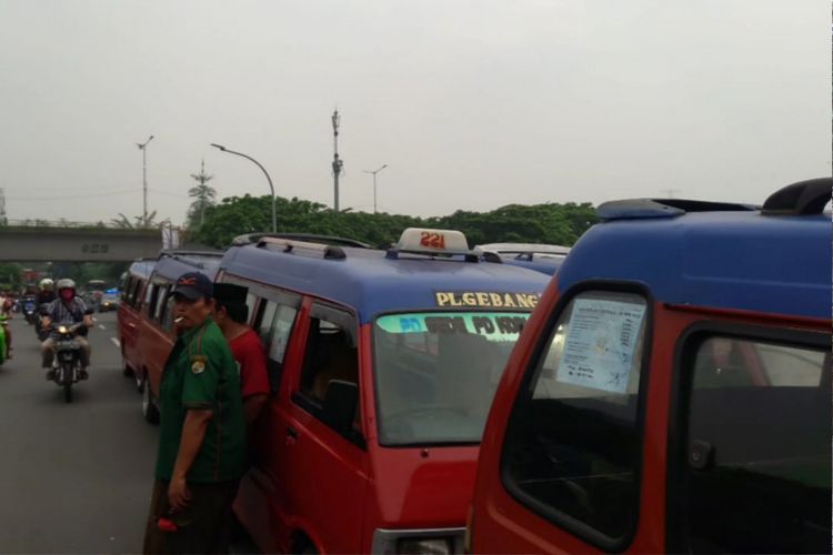 Sejumlah supir angkot mogor beroperasi menuntut dihentikannya trayek transjakarta jurusan Pulogadung-Pondok Gede, Senin (3/12/2018)