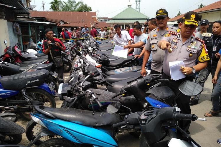 Kapolres Pelabuhan Belawan AKBP Ikhwan Lubis berdiri di antara puluhan sepeda motor yang diduga hasil kejahatan di Polsek Medan Labuhan.
