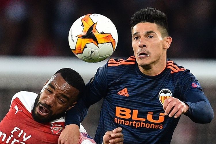 Facundo Roncaglia dan Alexandre Lacazette mencoba menyundul bola pada pertandingan Arsenal vs Valencia dalam semifinal Liga Europa di Stadion Emirates, 2 Mei 2019. 