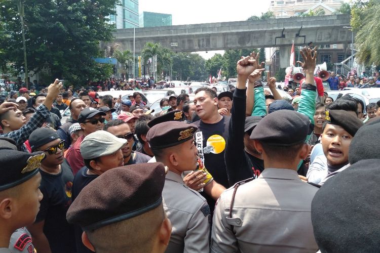 Ratusan masa aksi yang terdiri dari pengemudi Gocar mamaksa masuk ke kantor Gojek di Jalan Iskandarsyah, Melawai, Blok M, Jakarta Selatan, Senin (5/8/2109) 