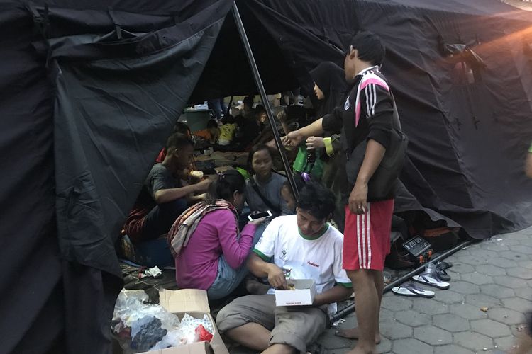 Warga korban kebakaran di Kampung Bandan, Ancol, Pademangan, Jakarta Utara, Senin (13/5/2019) buka puasa di posko pengungsian yang terletak di kawasan Grand Boutique. 