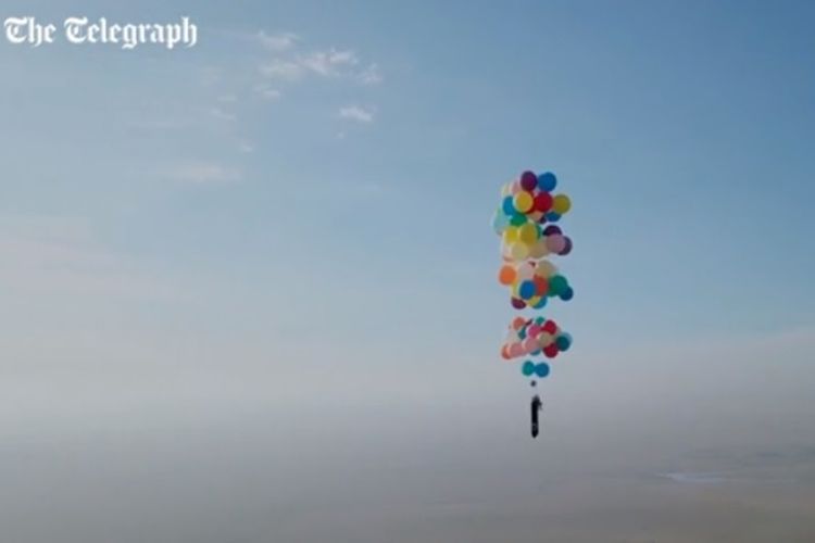 Pria Inggris, Tom Morgan saat terbang di langit Afrika Selatan menggunakan balon helium berwarna-warni.