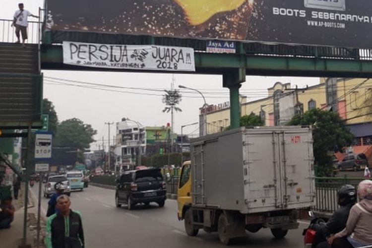 Tampak spanduk dukungan Persija terpasang di jembatan penyeberangan orang (JPO) depan Stasiun Kranji, Bekasi Barat, Kota Bekasi, Minggu (9/12/2018).