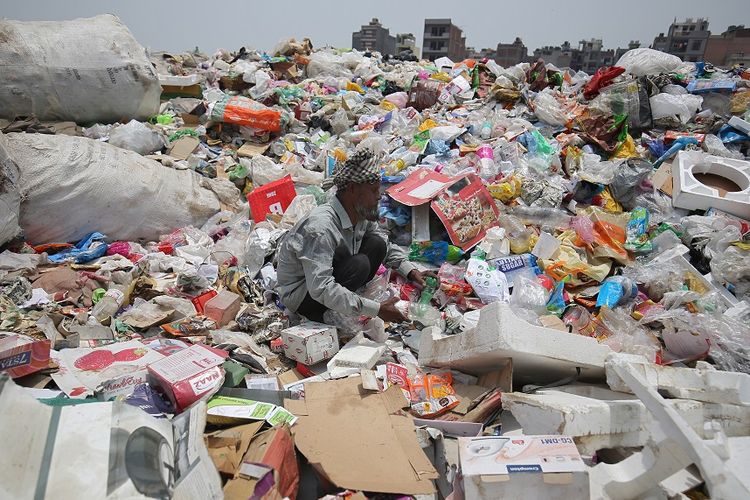 Seorang pria di India mengumpulkan sampah plastik di New Delhi.