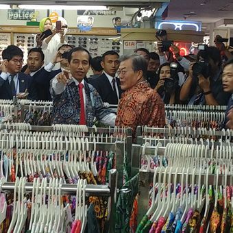 Presiden Joko Widodo dan Presiden Korsel Moon Jae-in menjajal batik di salah satu toko di Bogor Trade Mall di Bogor, Jawa Barat, Kamis (9/11/2017).