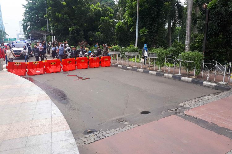 Petugas kepolisian memasang cone traffic berwarna oranye sebagai tanda bagi pengendara kendaraan bermotor tidak berbelok ke arah Dukuh Bawah dari arah Jalan Jenderal Sudirman. Foto diambil Rabu (13/2/2019).