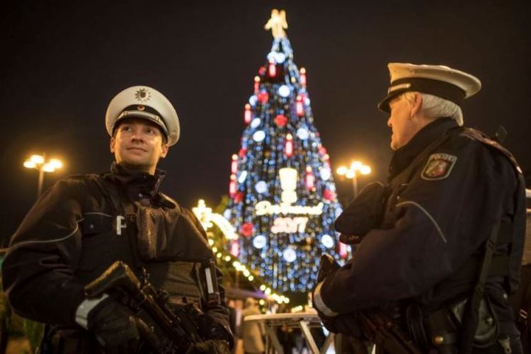 Petugas polisi berjaga di depan pohon Natal, di Pasar Natal, di Dortmund, Jerman, Senin (27/11/2017).
