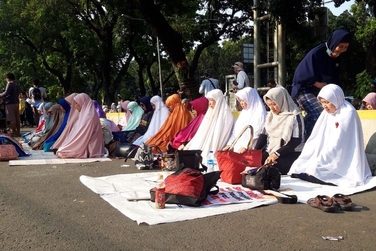 Massa aksi MK gelar shalat ashar berjamaah di Jalan Medan Merdeka Barat, Rabu (26/6/2019)