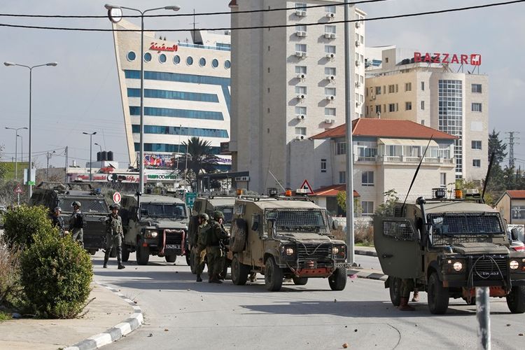 Tentara Israel saat memasuki wilayah Ramallah di Tepi Barat, pada Senin (10/12/2018), satu hari setelah insiden penembakan yang melukai tujuh orang di Ofra.