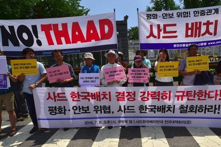 Para aktivis anti-perang melakukan unjuk rasa menentang rencana penempatan sistem pertahanan rudal THAAD di Korea Selatan.