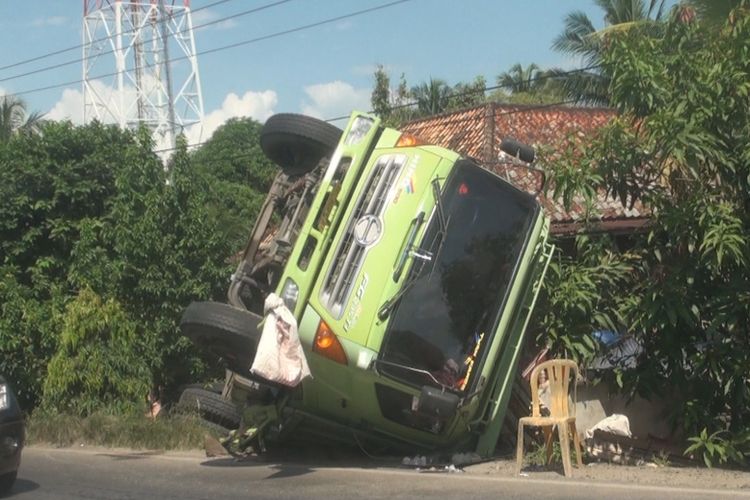 Truk fuso penuh muatan kaca yang terjungkal di sisi jalan lintas timur  Palembang-Ogan Ilir akibat menghindari tabrakan. Ratusan keping kaca pecah akibat kejadian itu