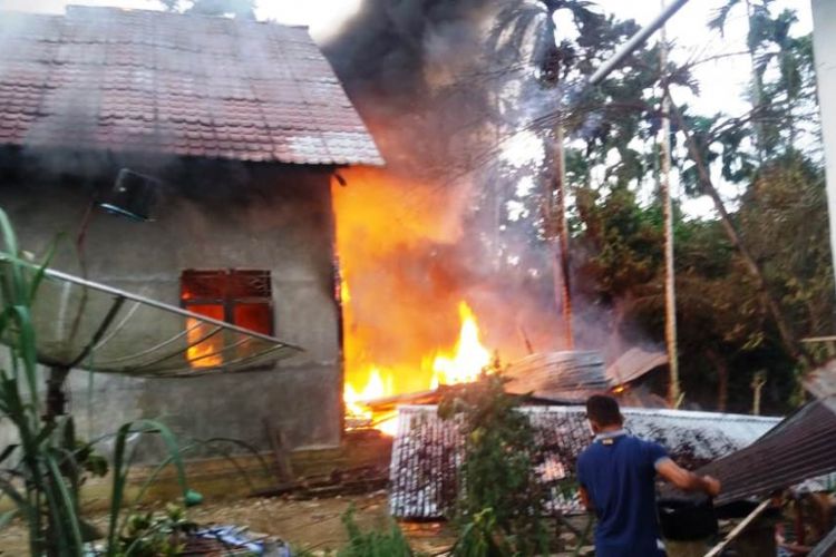 Warga berupaya menyelamatkan harta benda dari rumah Muslem (45) yang terbakar di Desa Ulee Gampong, Kecamatan  Cot Girek, Kabupaten Cot Girek, Jumat (24/8/2018). 