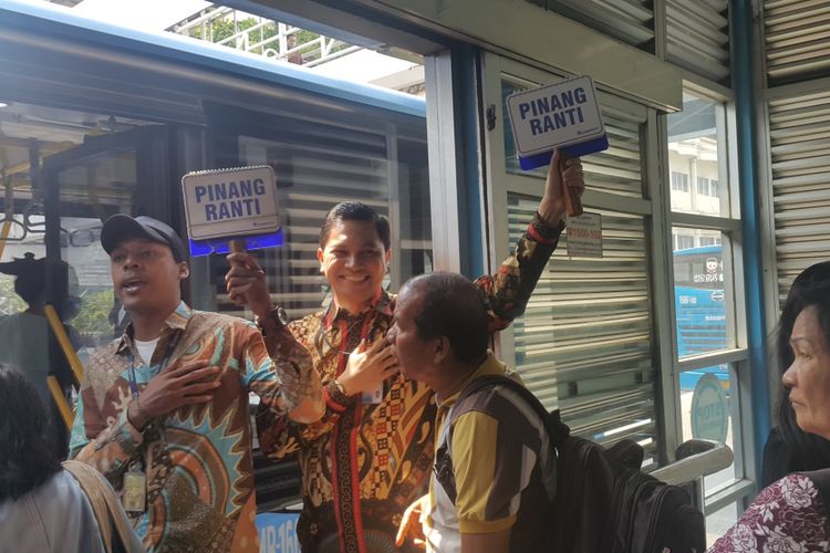 Direktur Operasional PT Transjakarta Daud Joseph (kanan memegang papan) saat bertugas menjadi petugas on board dalam rangka hari pelanggan nasional di Halte Harmoni, Jakarta Pusat, Kamis (14/9/2017).