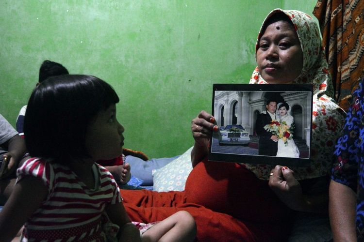 Yuni Fanani, istri Sunarko, menunjukkan foto memori pernikahan. Diduga akibat kelelahan, Sunarko, anggota KPPS di TPS 02 Desa Kepanjen Jombang Jawa Timur, meninggal dunia pada Senin (29/4/2019) malam.