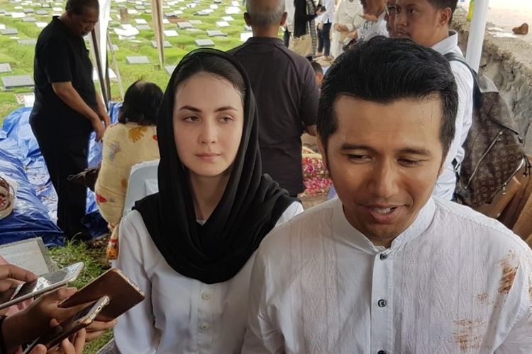 (kanan-kiri) Emil Dardak ditemani istrinya Arumi Bachsin dalam pemakaman adiknya Eril Dardak yang meninggal dunia akibat penyakit jantung di TPU Tanah Kusir, Kebayoran Lama, Jakarta Selatan pada Kamis (13/12/2018).