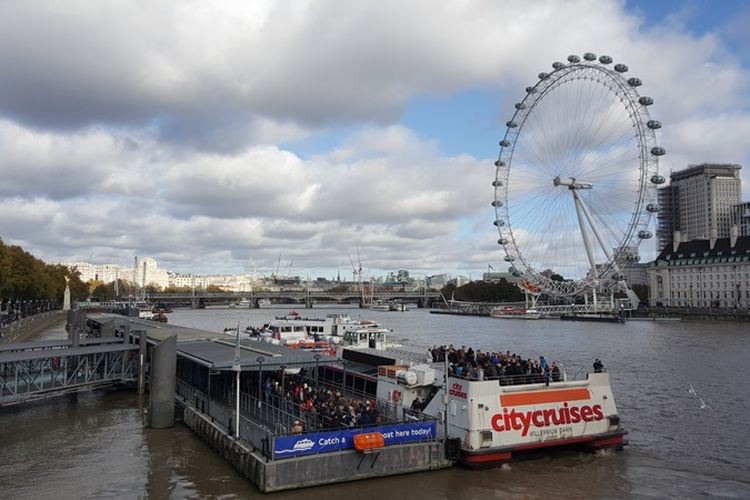 Suasana di Westminster Pier, tempat para peserta cruise tour berangkat untuk menyusuri Sungai Thames di London, Inggris, Minggu (5/11/2017). Tampak London Eye, ikon London, di seberangnya.