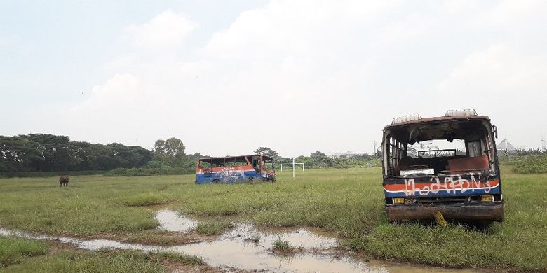 Bus tua yang ada di Terminal Mobil Rawa Buaya, Jakarta Barat berbagi lahan lapangan dengan kerbau liar pada Jumat (16/3/2018).