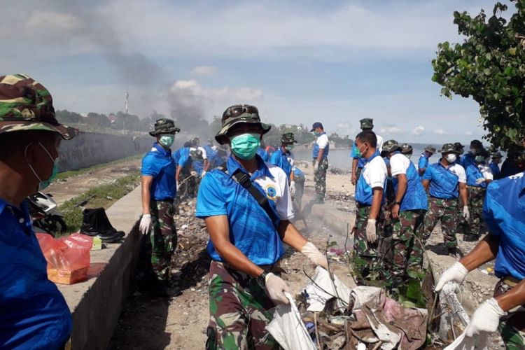 Aparat TNI sedang membersihkan sampah di sepanjang pantai di Kota Kupang, Selasa (5/3/2019). 