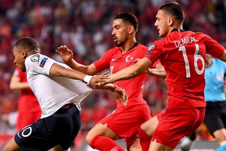 Merih Demiral (kanan) dan Irfan Kahveci mencoba menahan laju Kylian Mbappe pada pertandingan Turki vs Perancis dalam kualifikasi Euro 2020 di Stadion Buyuksehir Belediyesi, 8 Juni 2019. 