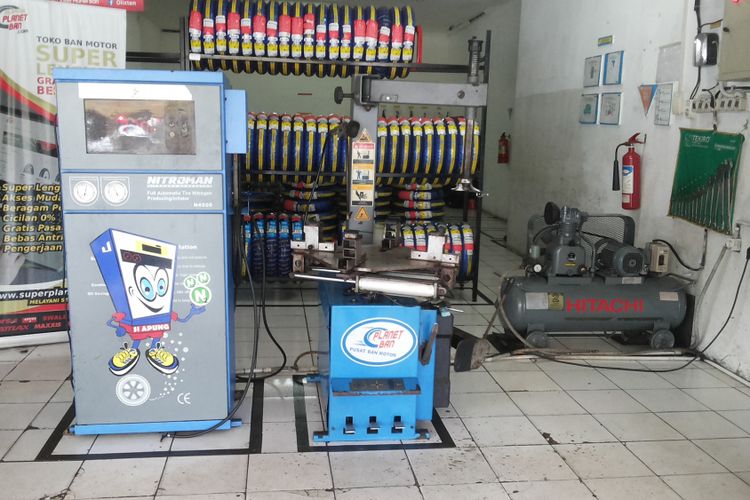 Salah satu outlet penjualan ban yang melayani pengisian ban dengan nitrogen di Depok, Kamis (8/2/2018). Tampak peralatan pengisian terdiri dari mesin generator dan tabung kompresor.