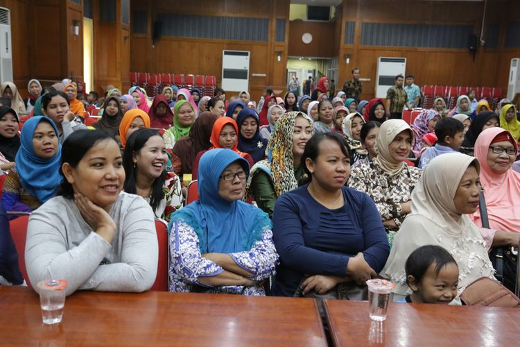 Para isteri pegawai outsourcing mendengarkan sambutan Wali Kota Surabaya Tri Rismaharini