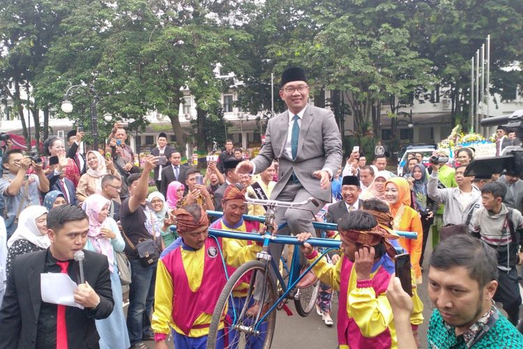 Gubernur Jawa Barat Ridwan Kamil diarak dengan sepeda yang dibopong saat akan meninggalkan Balai Kota Bandung, Jumat (21/2/2018).