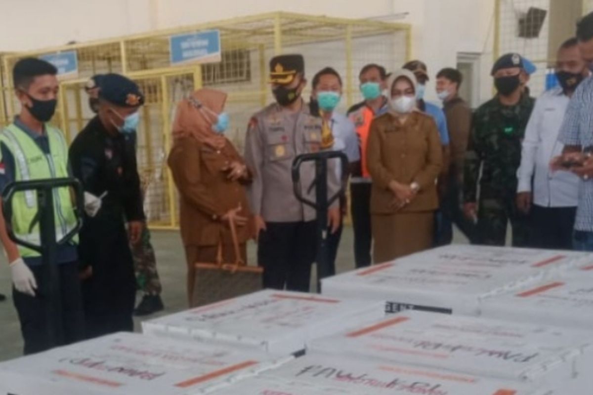 Members of the Indonesian Police and Military escort the Covid-19 vaccine from Sinovac Biotech Ltd in Halu Oleo Airport in Kendari, Southeast Sulawesi. 