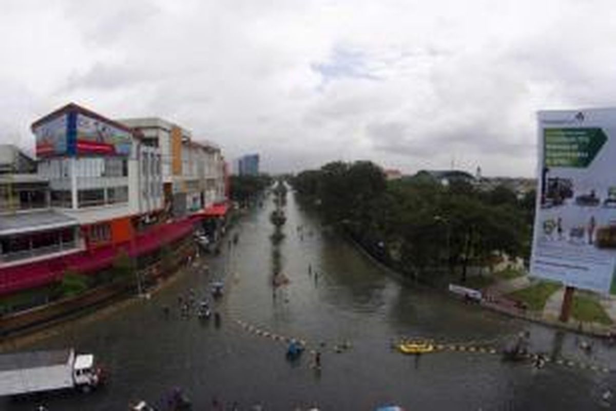 Banjir menggenangi kawasan permukiman dan perekonomian di Kelapa Gading, Jakarta Utara, Selasa (10/2/2015). Jakarta menghadapi masalah penurunan muka tanah. Kondisi itu diperparah oleh semakin minimnya daerah resapan air yang diganti dengan hunian dan gedung-gedung pencakar langit.