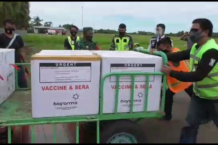 Men push a cart filled with Covid-19 vaccines in West Sulawesi. 