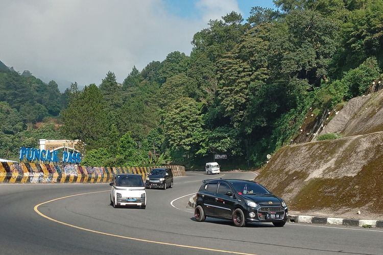 Sejumlah kendaraan melintasi jalur Puncak di kawasan Puncak Pass, Cianjur, Jawa Barat, Kamis (28/3/2024).