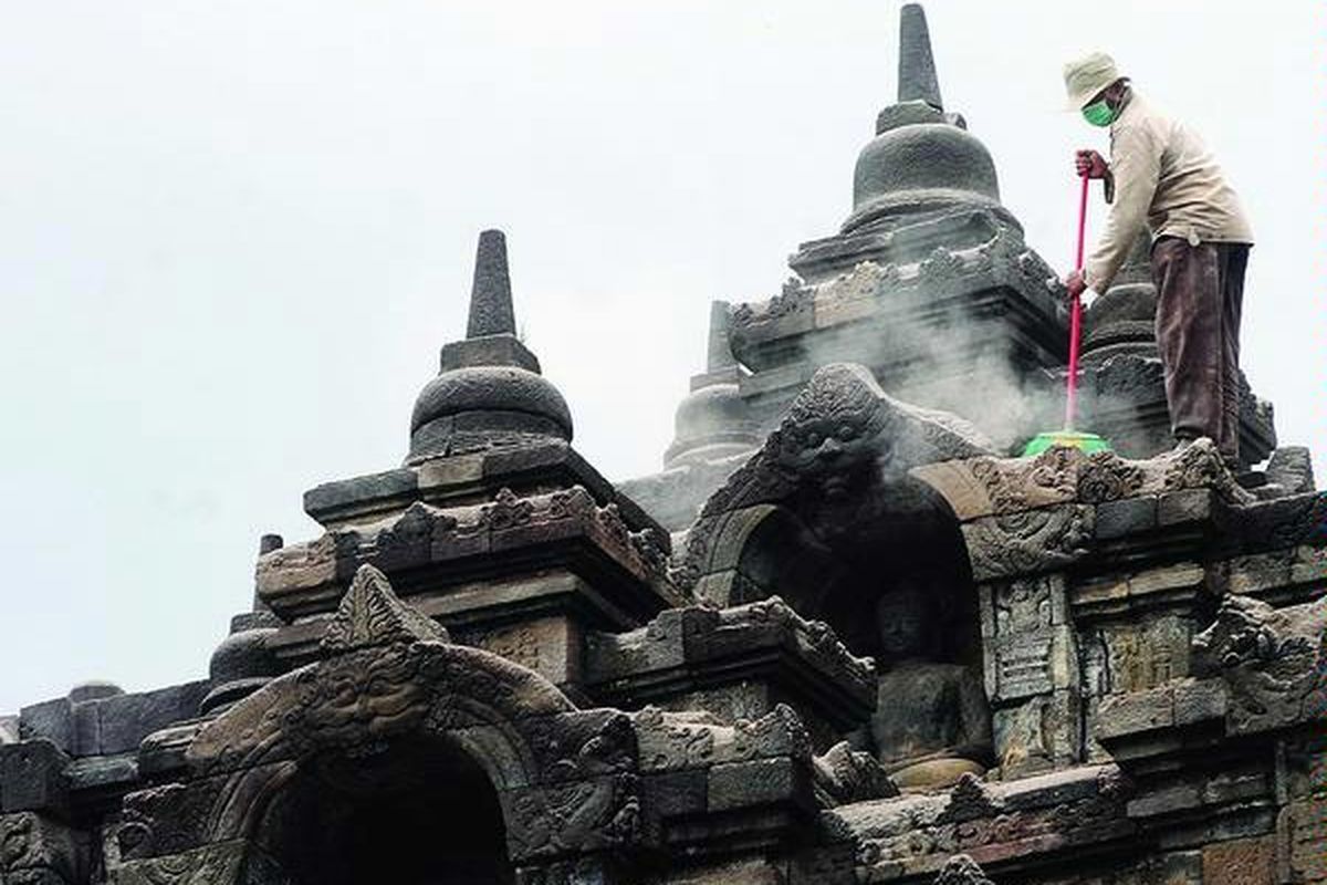 Pekerja di Candi Borobudur, Kabupaten Magelang, Jawa Tengah, beberapa waktu lalu, membersihkan abu vulkanik yang berasal dari letusan Gunung Merapi. 