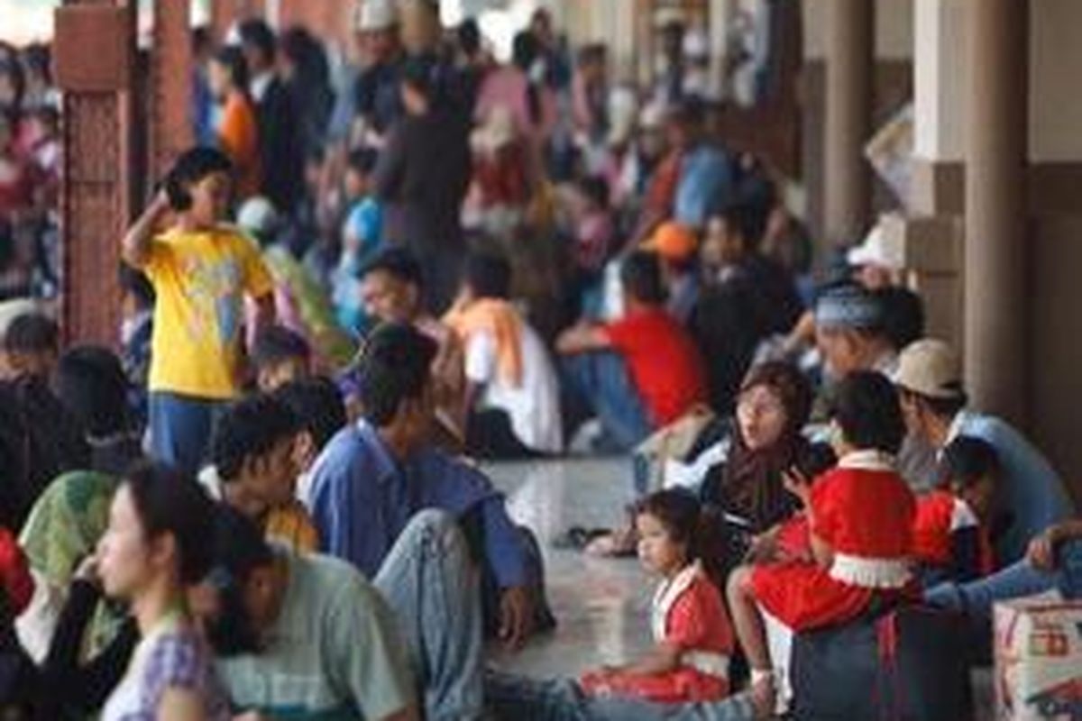 Pemudik menunggu datangnya rangkaian Kereta Api Ekonomi Kertajaya di Stasiun Pasar Senen, Jakarta Pusat, Jumat (19/9).