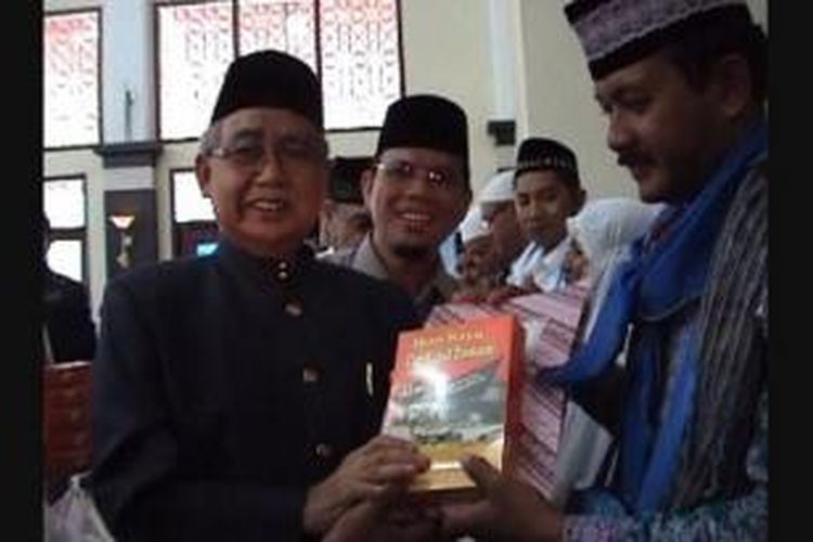 Gubernur Aceh Zaini Abdullah menyerahkan sekotak ikan kayu untuk jemaah haji asal aceh secara simbolis untuk dikonsumsi saat menunaikan ibadah haji.