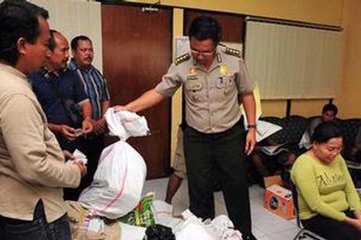 Kabid Humas Polda Bali Kombes Gede Sugianyar Dwi Putra sedang memeriksa 10 karung yang berisi kupon togel milik ratu togel Luh Mas yang dibekuk aparat gabungan Polda Bali, Kamis (24/3/2011).