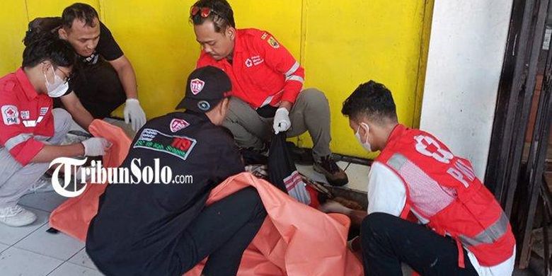 Tim relawan ketika mengevakuasi jenazah seorang pria yang ditemukan di emperan toko di Pasar Kota Sragen, Jawa Tengah, Selasa (4/7/2023).