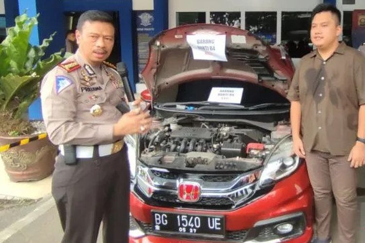 Aparat Direktorat Lalu Lintas Kepolisian Daerah Sumatera Selatan (Ditlantas Polda Sumsel) menunjukkan barang bukti mobil beridentitas asli dalam gelar ungkap kasus dugaan penggandaan identitas mobil di Markas Ditlantas Polda Sumsel, Palembang, Sumatera Selatan, Jumat (27/5/2022).