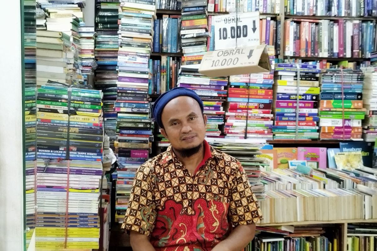 Subhil Khair Tobing (53) dan dagangan bukunya di Toko Buku Restu, Kwitang, Jakarta Pusat. (KOMPAS.com/Xena Olivia)