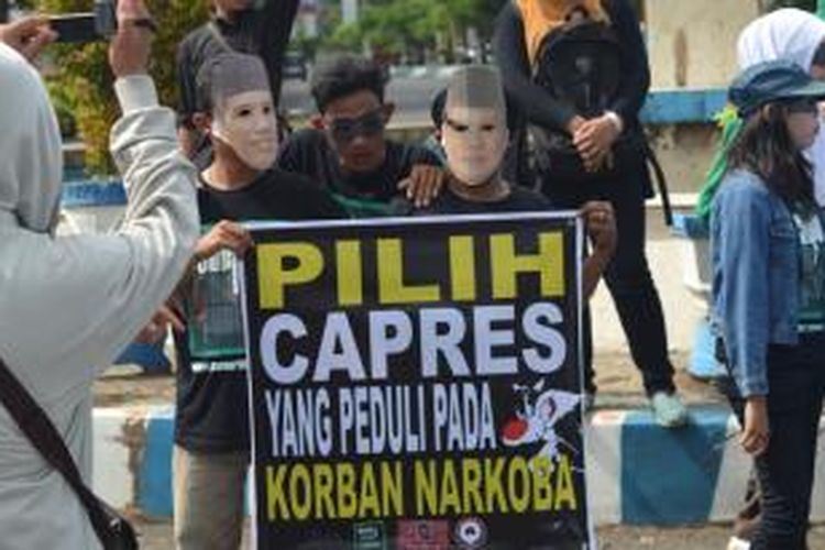 Peserta aksi unjuk rasa korban pecandu narkotika memakai topek Prabowo Subianto dan Joko Widodo, di Bengkulu